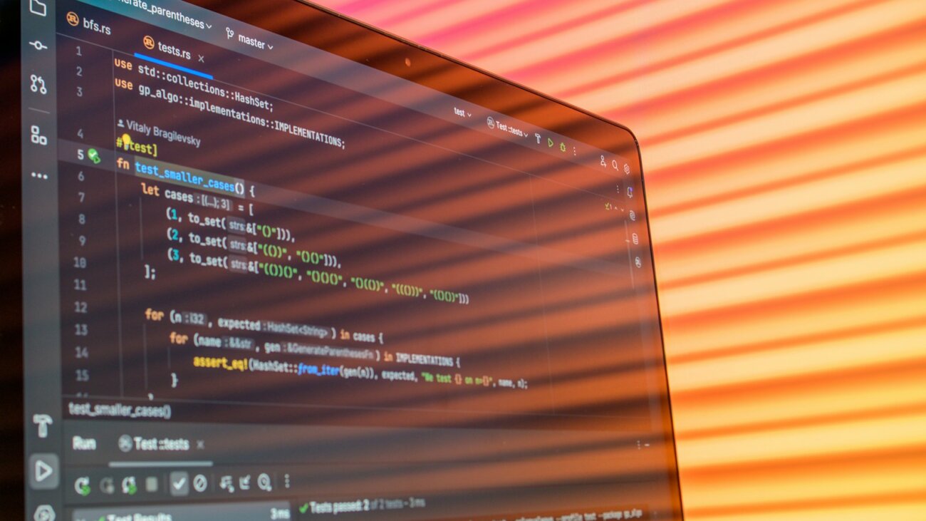 Laptop screen showing colourful code, the starting point of any CI/CD checklist