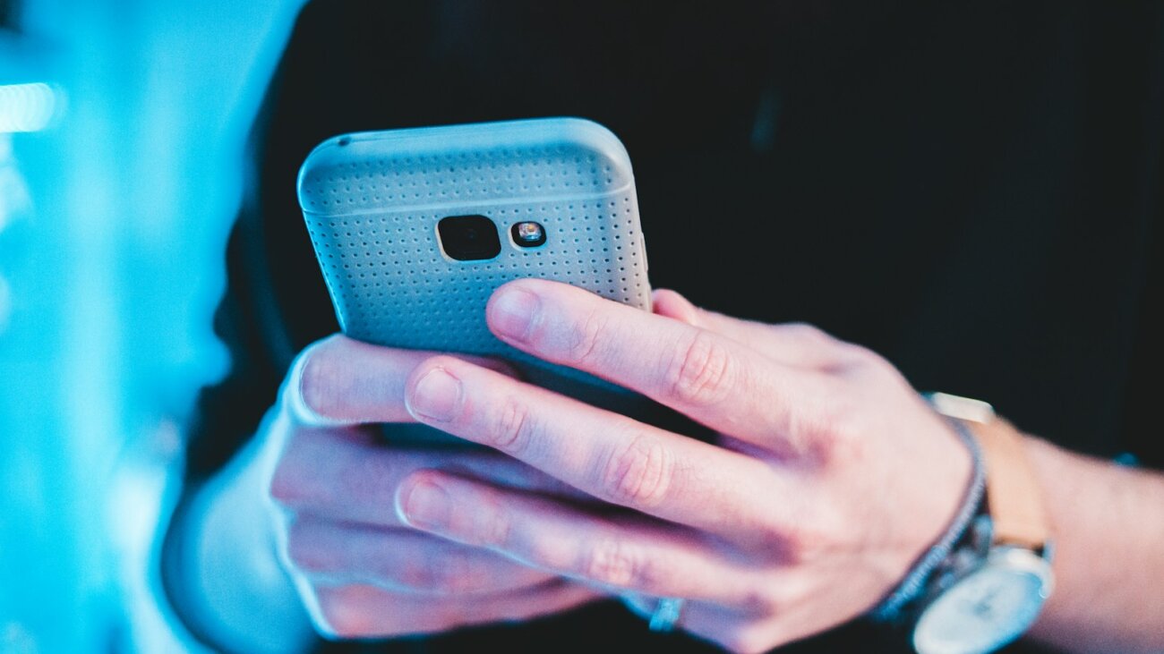 Person holding a smartphone, showing the importance of technology in daily life